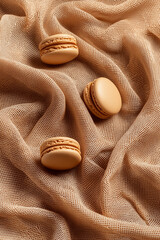 Delicate Beige Macarons Arranged Artfully on a Softly Draped Neutral Fabric Backdrop