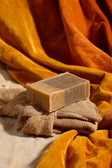 Handcrafted Soap Bar Still Life, Organic Bath Product, Amber and Beige Tones with Soft Fabric