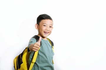 School boy looking confident and smiling while giving a thumbs-up. Ideal for school promotion, success or education ads.
