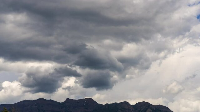 Time lapse of dramatic clouds rolling over Timpanogos mountain during the summer in Utah.