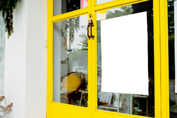 Mockup of white paper poster displayed outside a restaurant or cafe building. Marketing and...