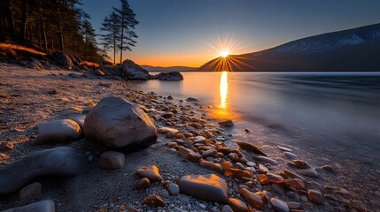 Stunning Sunset over Lake with Rocky Shore and Pine Trees