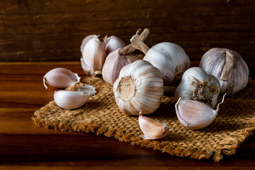 Fresh Garlic Bulbs on Rustic Table with Natural Wood Background