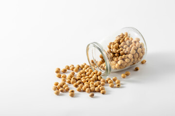 Spilled Soybeans from Glass Jar on White Background