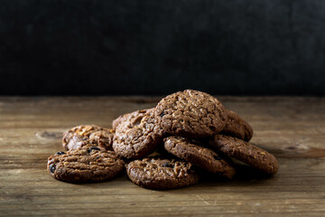 Freshly Baked Chocolate Cookies Stacked on Rustic Wooden Surface