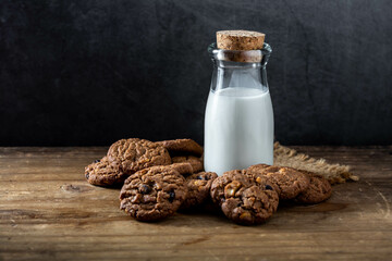 Delicious Homemade Chocolate Cookies with Bottle of Milk on Table