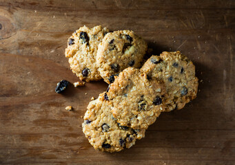 Freshly Baked Oatmeal Cookies with Raisins on Rustic Wooden Surface