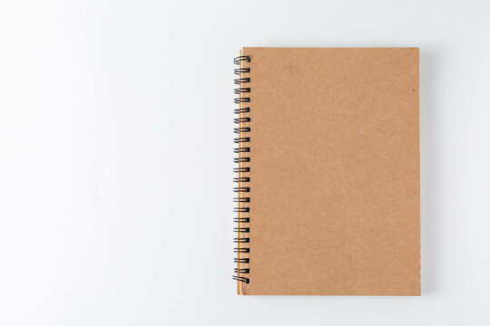 Plain Brown Spiral Notebook on White Background for Office Use