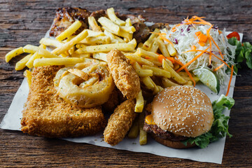 Delicious Plate of Fried Food with Burger, Fries, and Salad