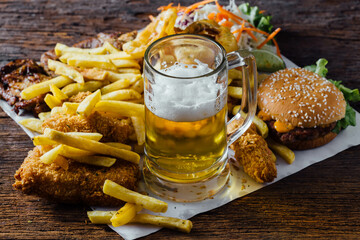 Delicious Spread of Fast Food and Refreshing Beer on Table
