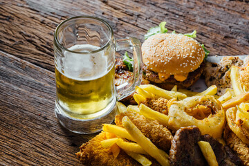 Delicious Pub Meal with Beer, Burger, Fries and Fried Snacks