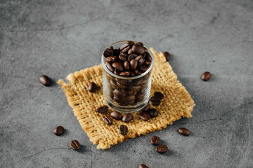 Freshly Roasted Coffee Beans in Glass Jar on Rustic Background