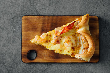 Delicious Slice of Pizza on Wooden Cutting Board Top View