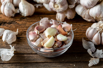 Fresh Garlic Cloves and Bulbs on Wooden Surface with Textures