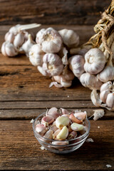 Fresh Garlic Bulbs and Cloves on Wooden Table with Natural Background
