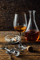 Elegant Glass of Amber Wine Beside Decanter and Accessories