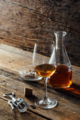 Elegant Glass of Amber Wine with Carafe and Corkscrew on Table