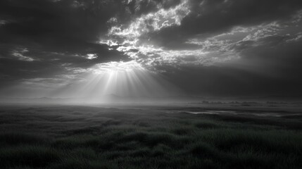 Dramatic Monochrome Landscape with Sunbeams Breaking Through Clouds