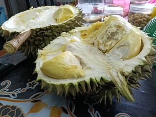 Opened Durio zibethinus or durian fruit on the table close-up.musang king variety. photo taken in...