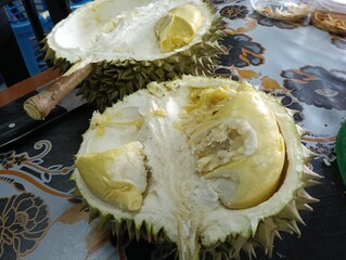 Opened Durio zibethinus or durian fruit on the table close-up.musang king variety. photo taken in...