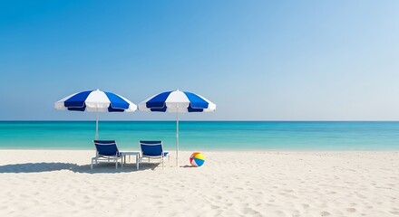 Two beach chairs and umbrellas on a white sand beach with a colorful ball