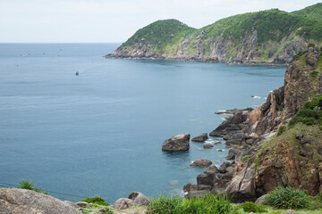 A lone boat drifts in the distance, emphasizing the vastness and tranquility of this natural...