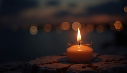 A warm candle flame illuminates a peaceful evening scene with bokeh lights in background.
