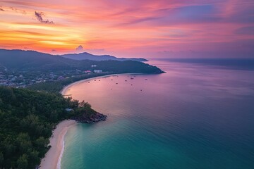 Fototapeta premium Stunning sunset over Tri Trang beach, Phuket Island showcasing vibrant colors and serene ocean waves, Phuket island sunset seascape aerial view Tri Trang beach Patong bay Thailand