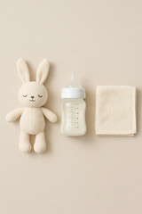 Cute baby bottle mockup with sleeping bunny plush toy and towel flat lay concept for baby care design branding or parenting blog product presentation