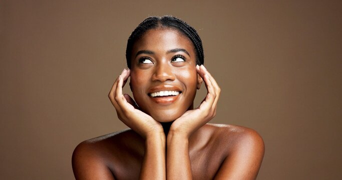 Beauty, face and thinking with black woman on studio space for cosmetics or dermatology planning. Ideas, inspiration and skincare with smile of happy African model isolated on brown background