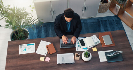 Above, business and man on laptop in office for finance report, budget plan and auditing. Male person, typing and pc with documents, company expenditure and global information for marketing proposal