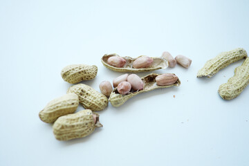  Fresh peanuts, some shelled and ready for a healthy snack or culinary use.