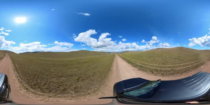 360vr spherical footage SUV car driving on road on top of mountain on Lake Baikal, summer steppe landscape around, mountains of national park, clouds in blue sky, view from above_4K virtual immersive