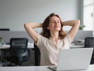 30-year-old caucasian woman relaxing with hands behind head in front of laptop in office - work-life balance concept