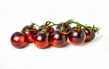 Black cherry tomatoes bunch isolated on white background. Horizontal orientation, close-up. Healthy eating concept