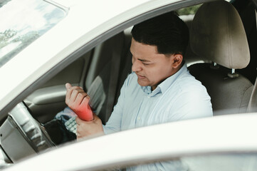 Driver with pain in hands. Male driver on car with wrist pain