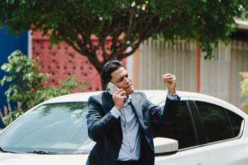 Angry male driver on call outside car. Man arguing on call outside the car
