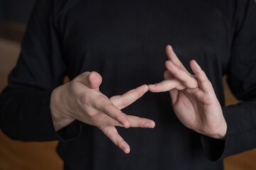 A man shows the word internet in Russian sign language. 