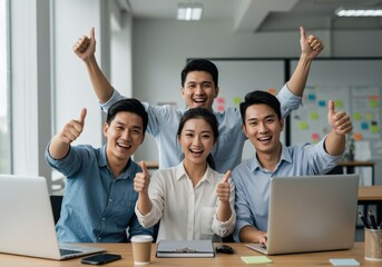 business team celebrating with thumbs up in bright modern office