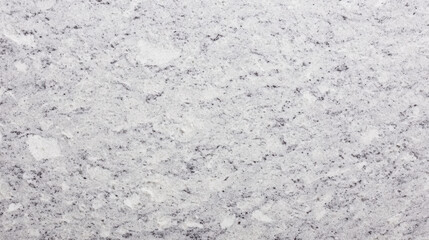 The textured surface of white granite rock shows an abstract and natural pattern with visible color variations and specks, creating a background ideal for designs.