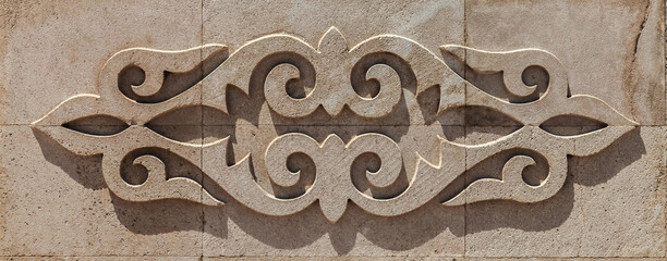 A stone carving of a design with a lot of detail