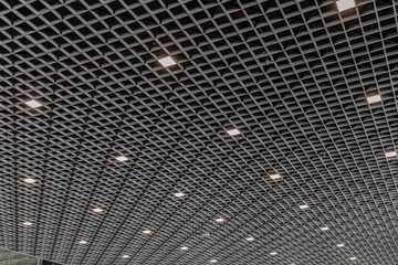 Suspended ceiling with lamps. The lamps are evenly distributed, the ceiling is empty.