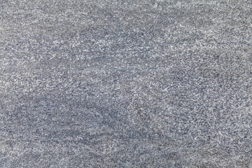 A grey and white surface with a lot of small dots