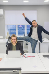 Colleagues fooling around at work in the office. 