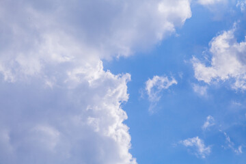 The sky is blue with a few clouds. The clouds are white and fluffy. The sky is clear and bright