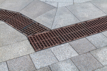 Brick walkway with a grate in the middle