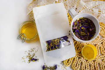 White packaging with herbal tea mockup for logo or inscription and white cup with healthy natural...