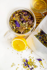 Cup of healthy natural herbal tea next to lemon and honey on a light background. Healthy drink.