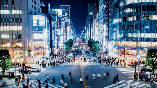 Night cityscape view of Ginza district with many people and city lights, perfect for time lapse or
