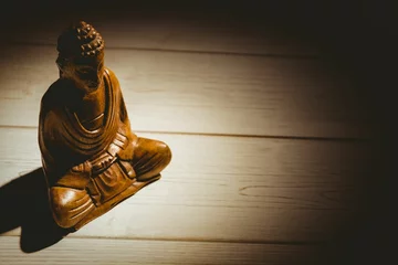 Poster Buddha statue on hardwood floor